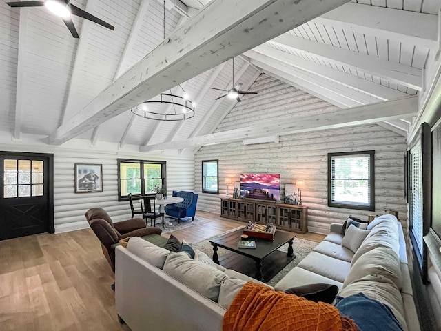 living room with log walls, vaulted ceiling with beams, light hardwood / wood-style floors, and plenty of natural light