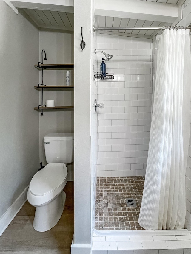 bathroom with a shower with curtain, hardwood / wood-style flooring, and toilet