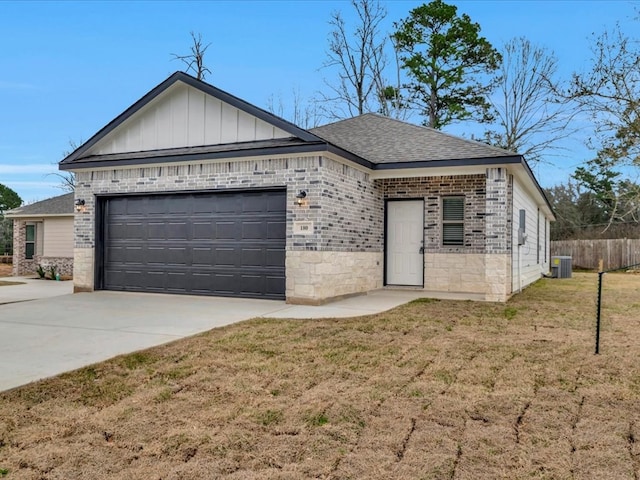 ranch-style home featuring brick siding, board and batten siding, a front yard, a garage, and driveway