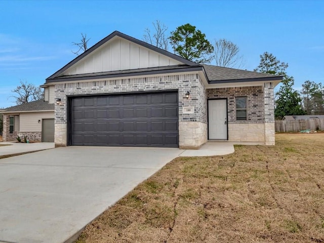 ranch-style home with driveway, an attached garage, a front yard, board and batten siding, and brick siding