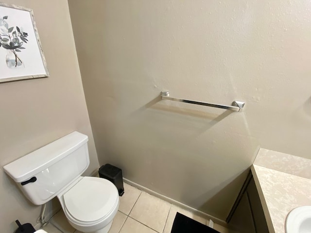 bathroom featuring tile patterned flooring, vanity, and toilet