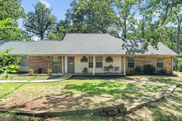 176 Bending Oak Dr, Pollok, TX 75969 - view of front facade with a front lawn, a shingled roof, and brick siding