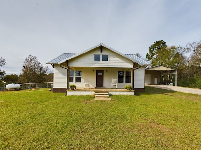 view of front of house with a carport, covered porch, and a front lawn