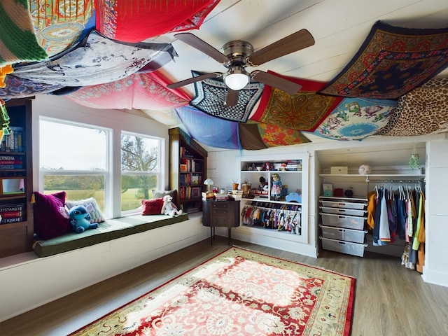 interior space featuring wood-type flooring and ceiling fan