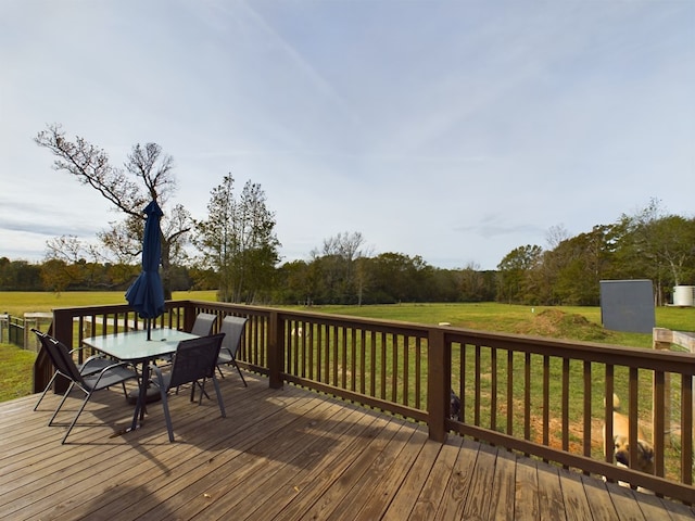 wooden terrace featuring a lawn