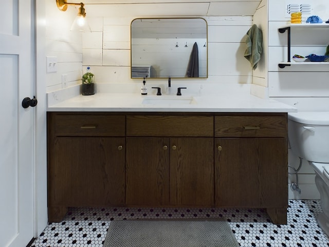 bathroom featuring tile patterned flooring, vanity, and toilet