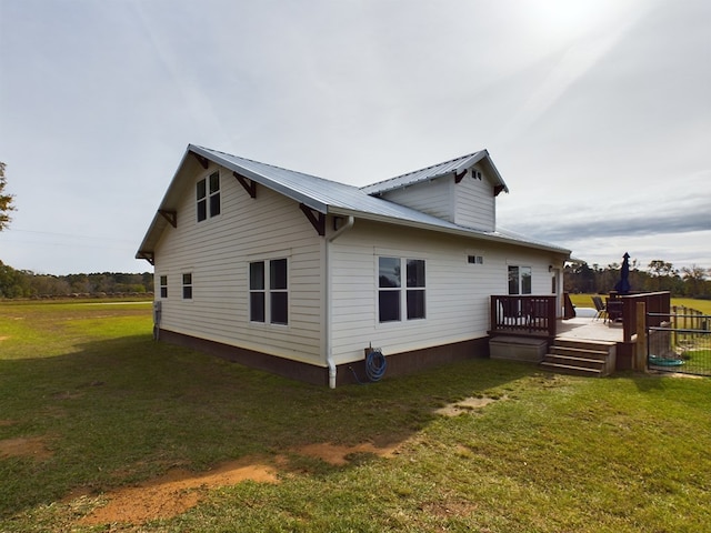 view of property exterior featuring a lawn and a deck