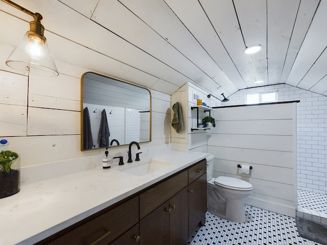 bathroom featuring vanity, wood walls, a shower, lofted ceiling, and toilet