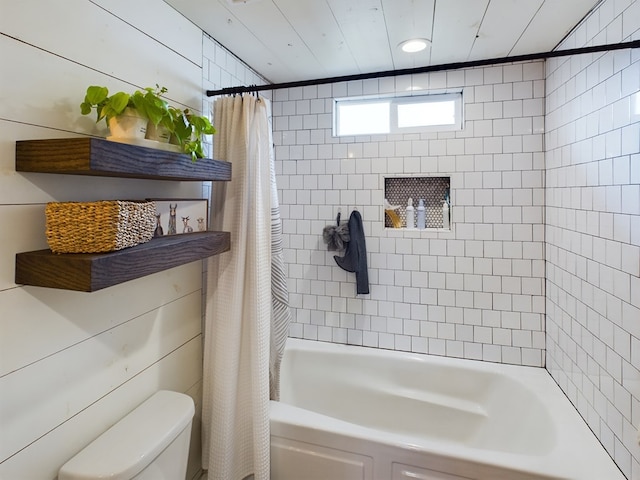 bathroom with toilet, shower / bathtub combination with curtain, and wooden walls