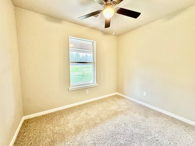 empty room featuring carpet flooring and ceiling fan