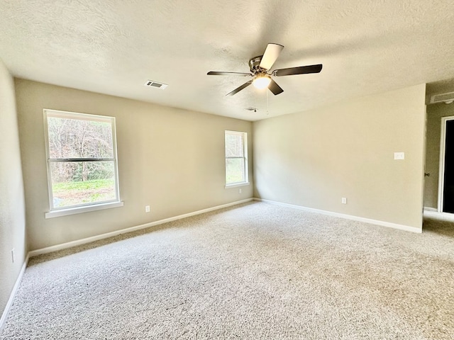 unfurnished room featuring carpet flooring, a textured ceiling, and ceiling fan