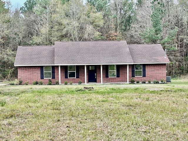 ranch-style house featuring a front yard and central AC