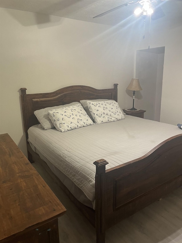 bedroom featuring dark hardwood / wood-style floors and ceiling fan