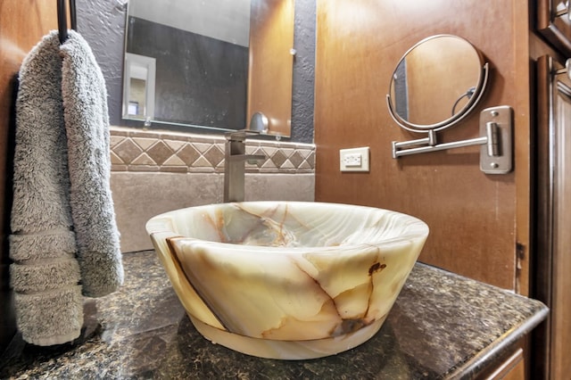 bathroom with sink and tile walls