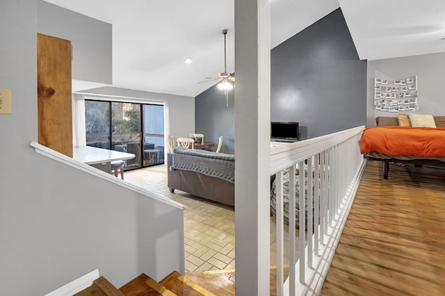 living room featuring ceiling fan and lofted ceiling