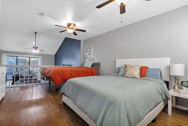 bedroom featuring ceiling fan, dark wood-type flooring, and lofted ceiling