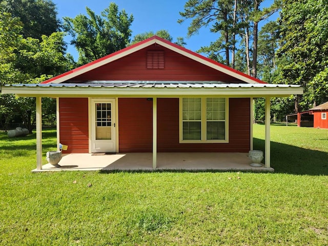 4710 County Road 082, Jasper, TX 75951 - back of house featuring a patio area, a yard, and a metal roof