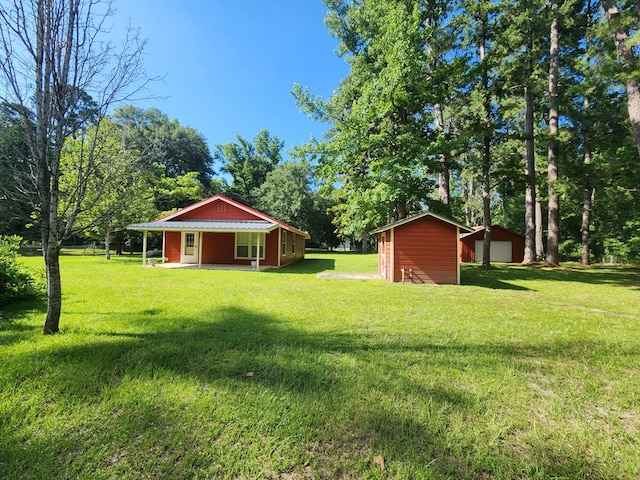4710 County Road 082, Jasper, TX 75951 - view of green lawn with a storage shed, a garage, and view of scattered trees