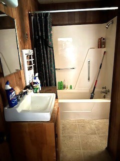 bathroom with shower / bath combo, tile patterned flooring, and vanity