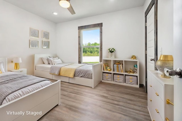 bedroom with wood finished floors, recessed lighting, and ceiling fan