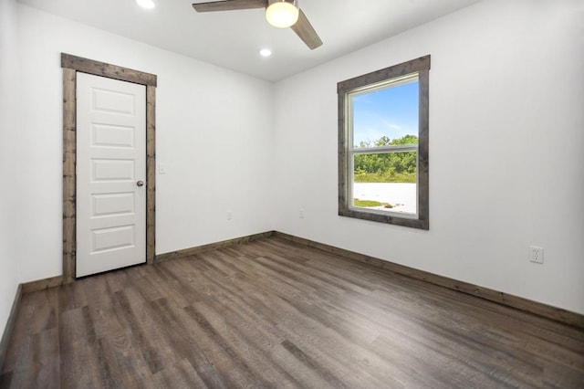 empty room featuring dark wood-type flooring, ceiling fan, recessed lighting, and baseboards
