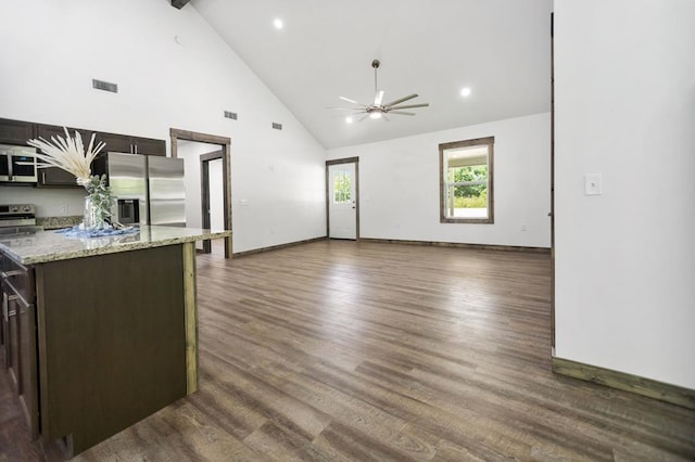 unfurnished living room featuring a ceiling fan, high vaulted ceiling, baseboards, dark wood finished floors, and beam ceiling