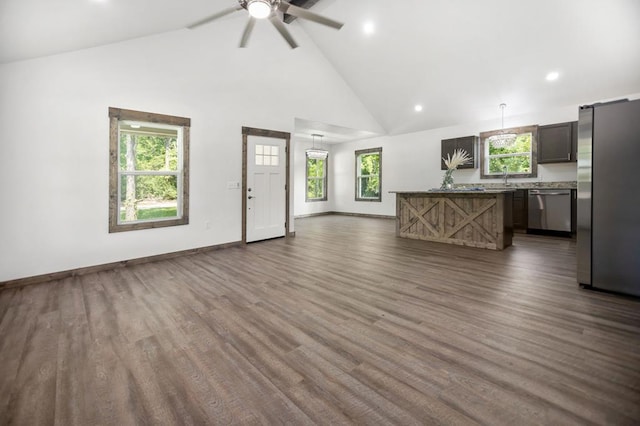 unfurnished living room with high vaulted ceiling, ceiling fan, dark wood-style floors, recessed lighting, and baseboards