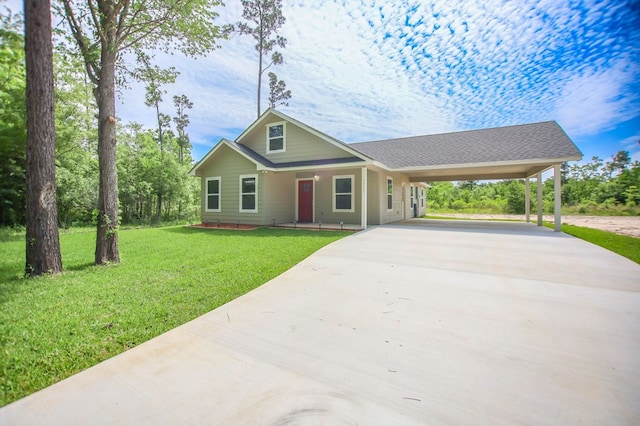 view of front of property with concrete driveway, a front yard, a carport, and covered porch