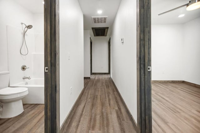 hall featuring wood finished floors and baseboards