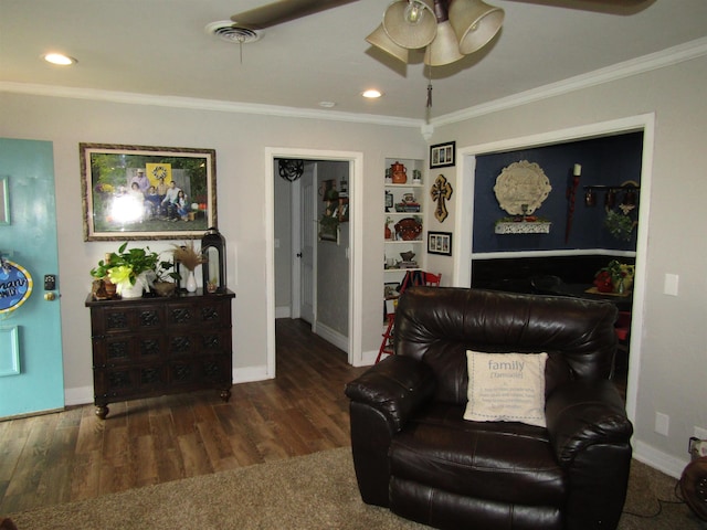 living room with dark hardwood / wood-style flooring, ceiling fan, and crown molding