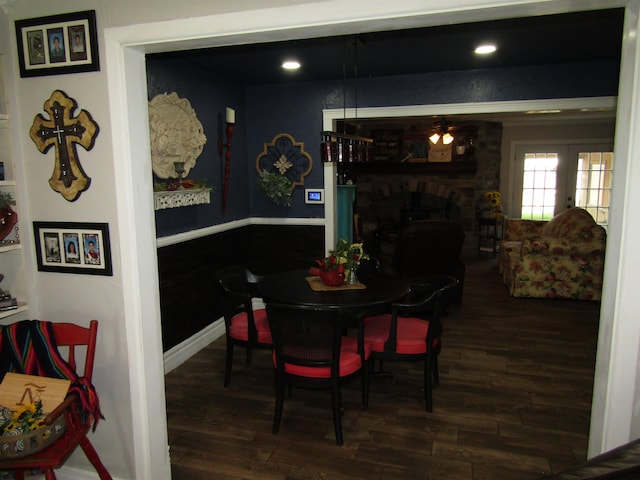 dining area with a fireplace and dark wood-type flooring