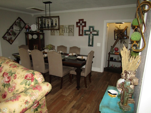 dining room with dark hardwood / wood-style floors and crown molding