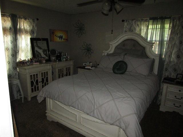 bedroom with ceiling fan and dark carpet