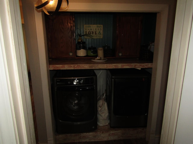 clothes washing area with washing machine and clothes dryer