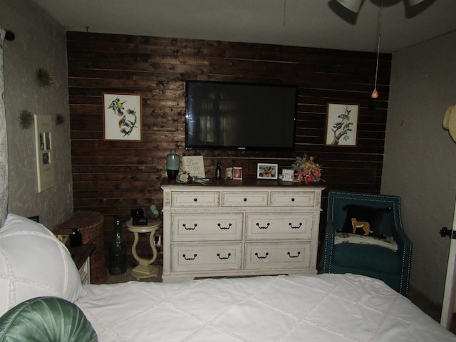 bedroom featuring wooden walls