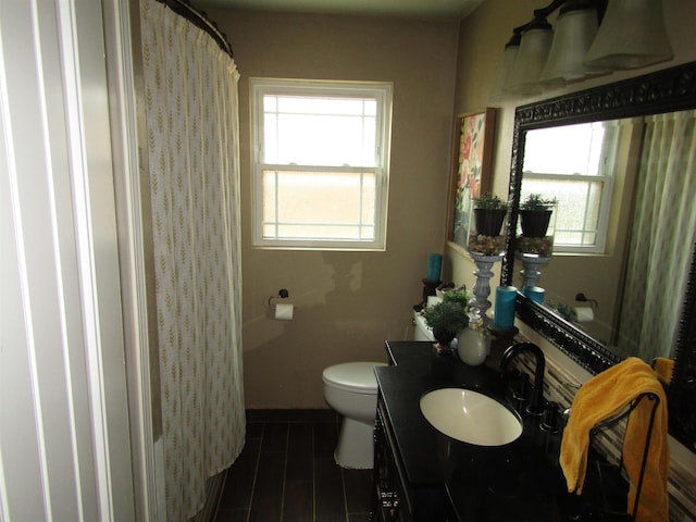 full bathroom with vanity, shower / bath combo, and toilet