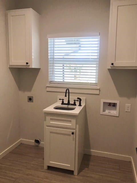 washroom featuring hookup for an electric dryer, hookup for a washing machine, dark hardwood / wood-style flooring, and sink