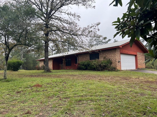 single story home with a garage and a front lawn