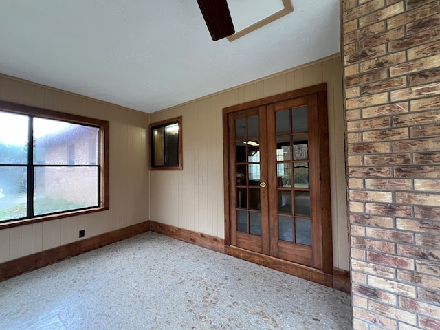 empty room featuring french doors and a textured ceiling