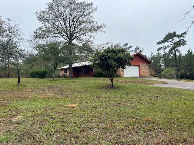 view of front of house with a garage and a front lawn