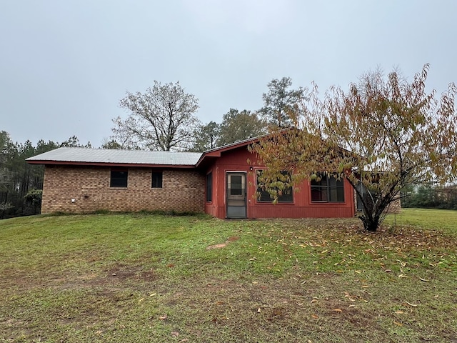 back of house with a lawn