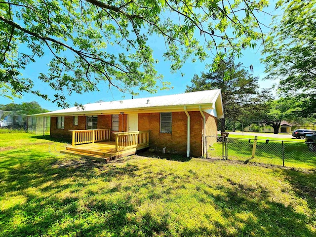 1100 Worth St, Hemphill, TX 75948 - view of front of property with a deck, brick siding, and a gate