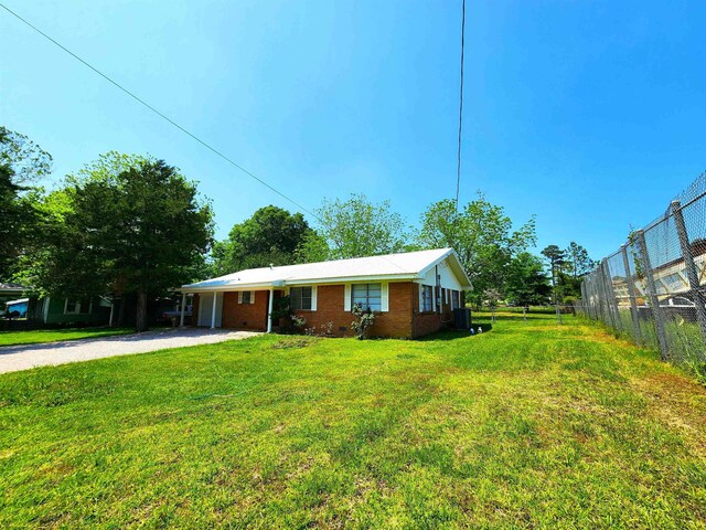 view of front of house featuring cooling unit and a front lawn