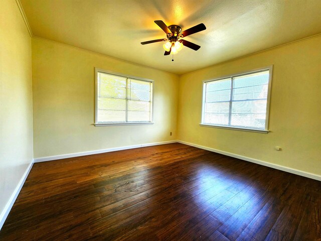 spare room with crown molding, ceiling fan, and dark hardwood / wood-style flooring