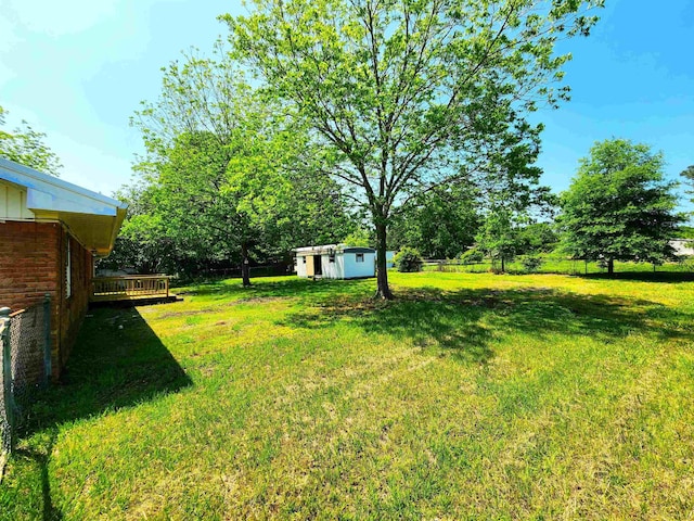 1100 Worth St, Hemphill, TX 75948 - view of yard with a wooden deck and a storage unit