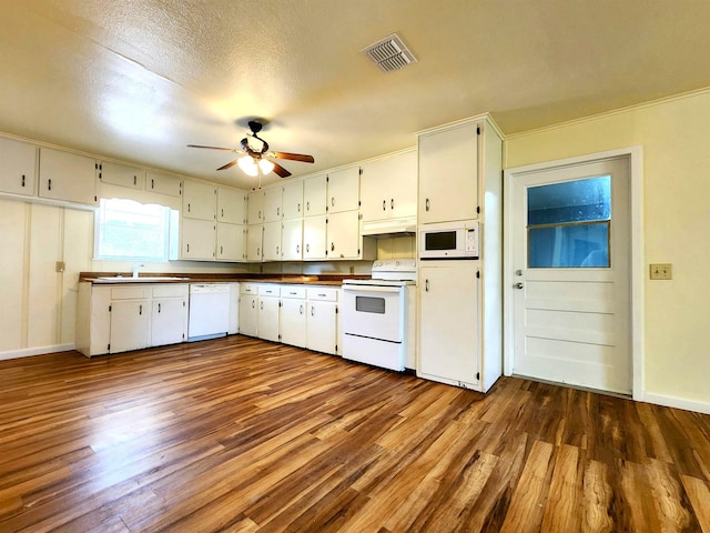 kitchen featuring white cabinetry, white appliances, dark wood-type flooring, and sink