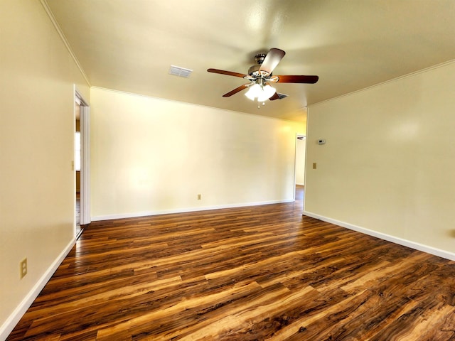 spare room featuring ceiling fan, ornamental molding, and dark hardwood / wood-style floors