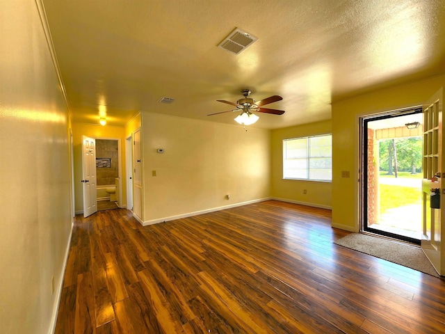 empty room featuring ceiling fan, dark hardwood / wood-style floors, and a textured ceiling