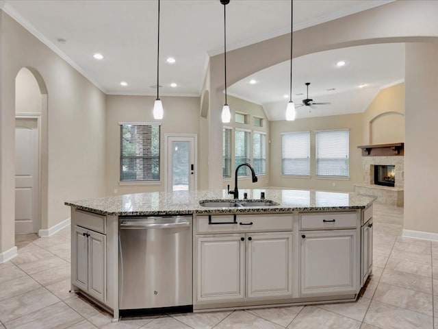 kitchen with dishwasher, sink, and an island with sink