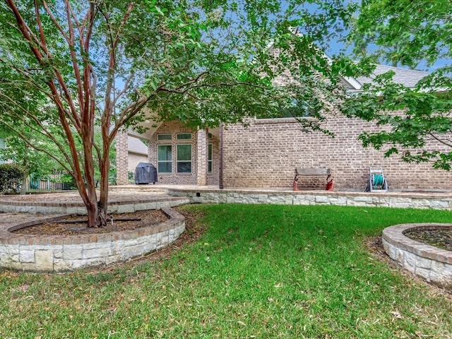 rear view of property featuring a lawn